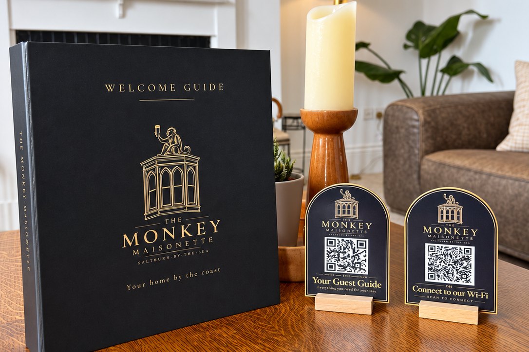 The Monkey Maisonette printed welcome guide and two personalised QR plaques in the property.